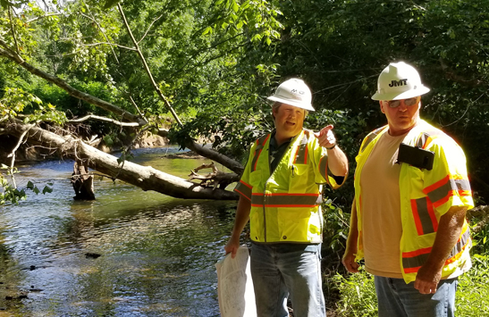 It was easier to explain the MD 355 project to a customer in person, says, D7 Construction Project Engineer Philip Brentlinger, left, shown here discussing related stream restoration with a contractor.